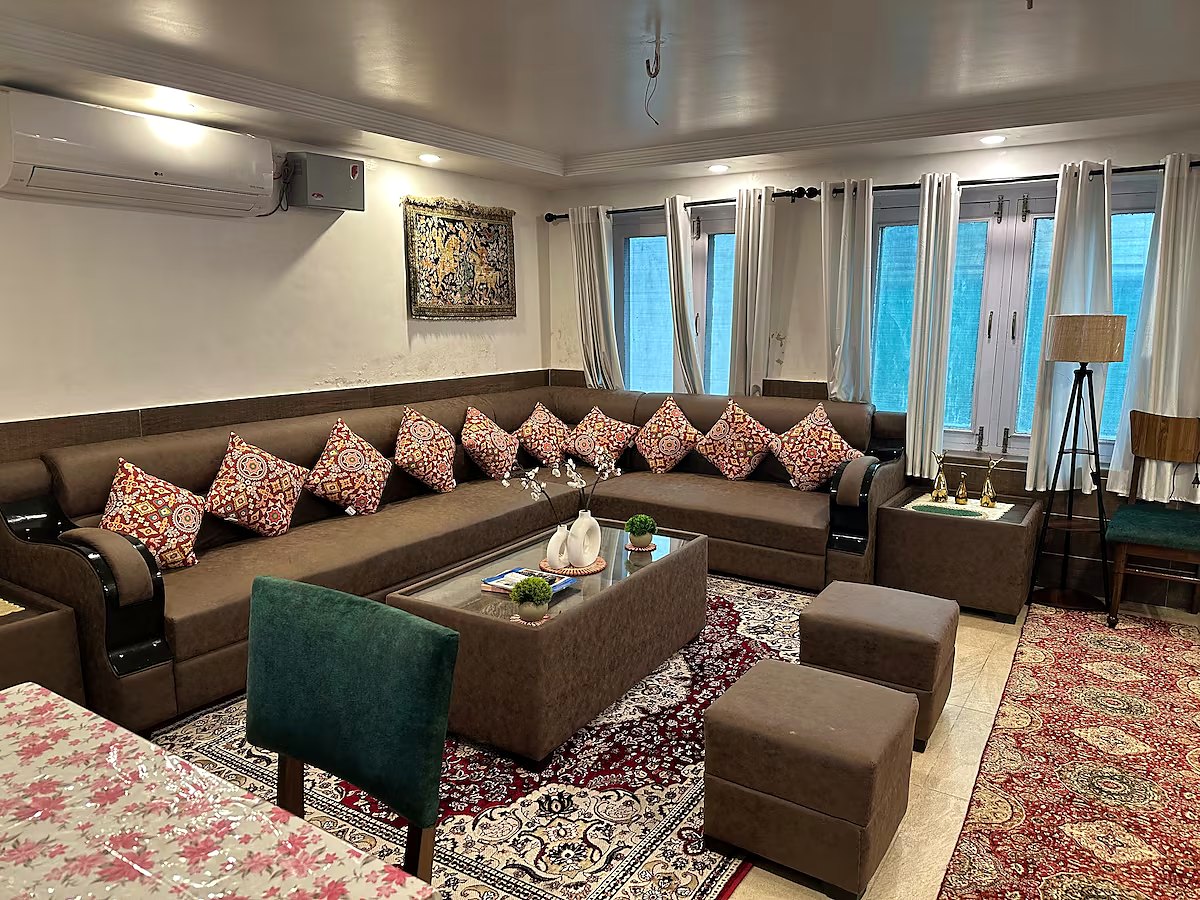 Ground floor living area with comfortable seating and television