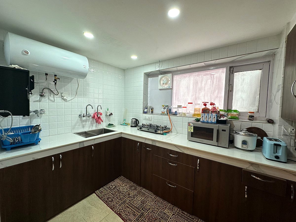 Full kitchen with fridge, utensils, and appliances at Chinar House