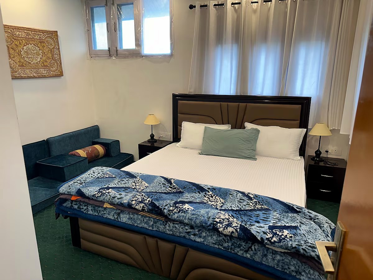 Bedroom two at Chinar House with bed and seating